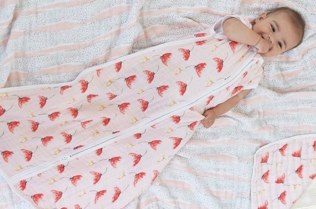 15 of the Best Baby Sleep Sacks That Will Keep Them Safe, baby in a mermaid print sleep sack.